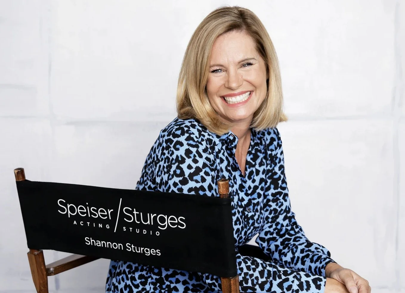 Shannon Sturges seated in a navy study lit by a film light